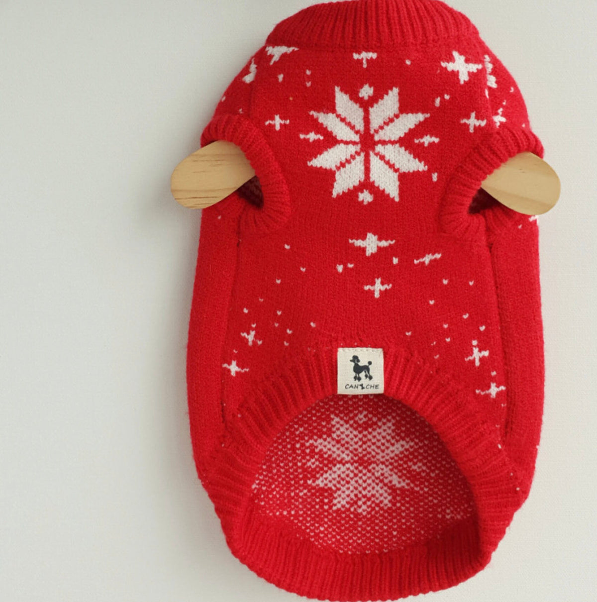 Red Christmas Tree knit dog vest with white snowflake patterns.