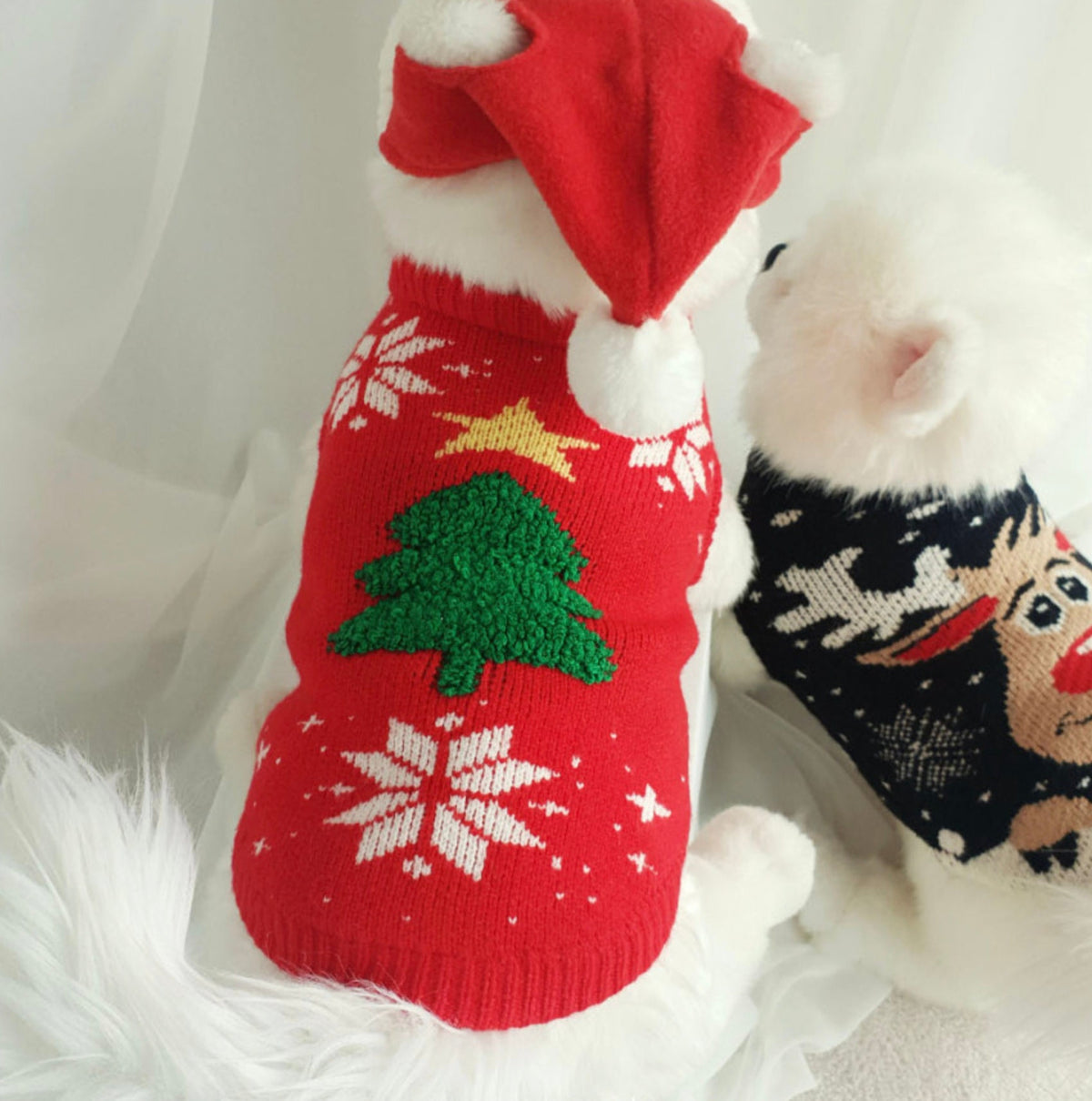Red Christmas tree knit dog vest with white snowflake patterns and a matching red Santa hat