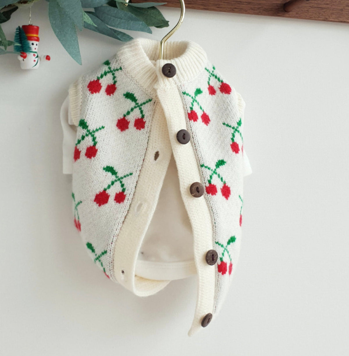 Christmas cherry knit dog cardigan in white with red cherry pattern and brown buttons