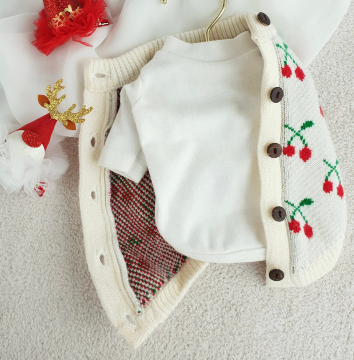 Christmas cherry knit dog cardigan in white with red cherry patterns and brown buttons
