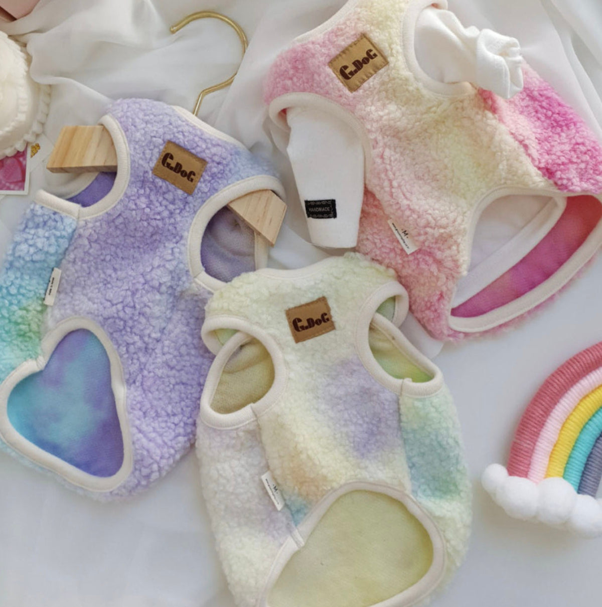 NKpup Aurora Boa Fleece Dog Vests in pastel purple, pink, and yellow gradient colors.