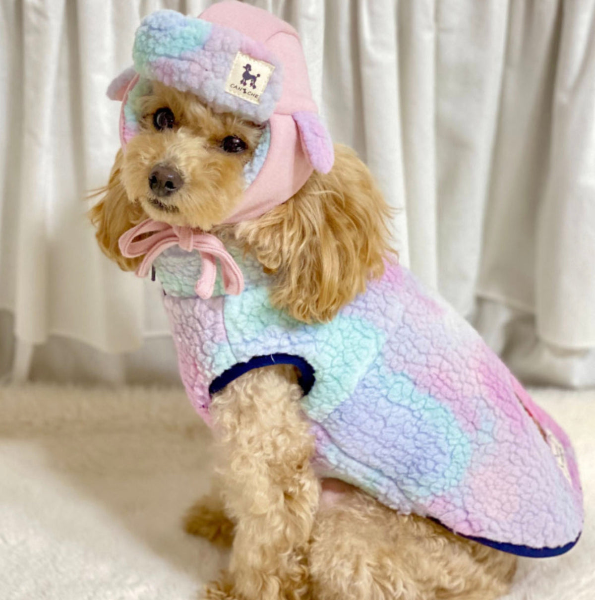 Bear fleece dog vest in a pastel pink, blue, and purple tie-dye pattern with a matching hood.