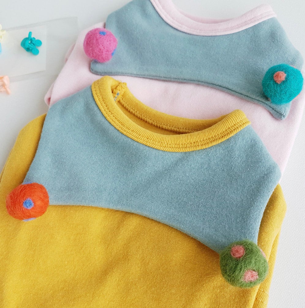 NKpup Ball Collar Dog Shirts in yellow, pink, and blue with colorful pom-pom accents.