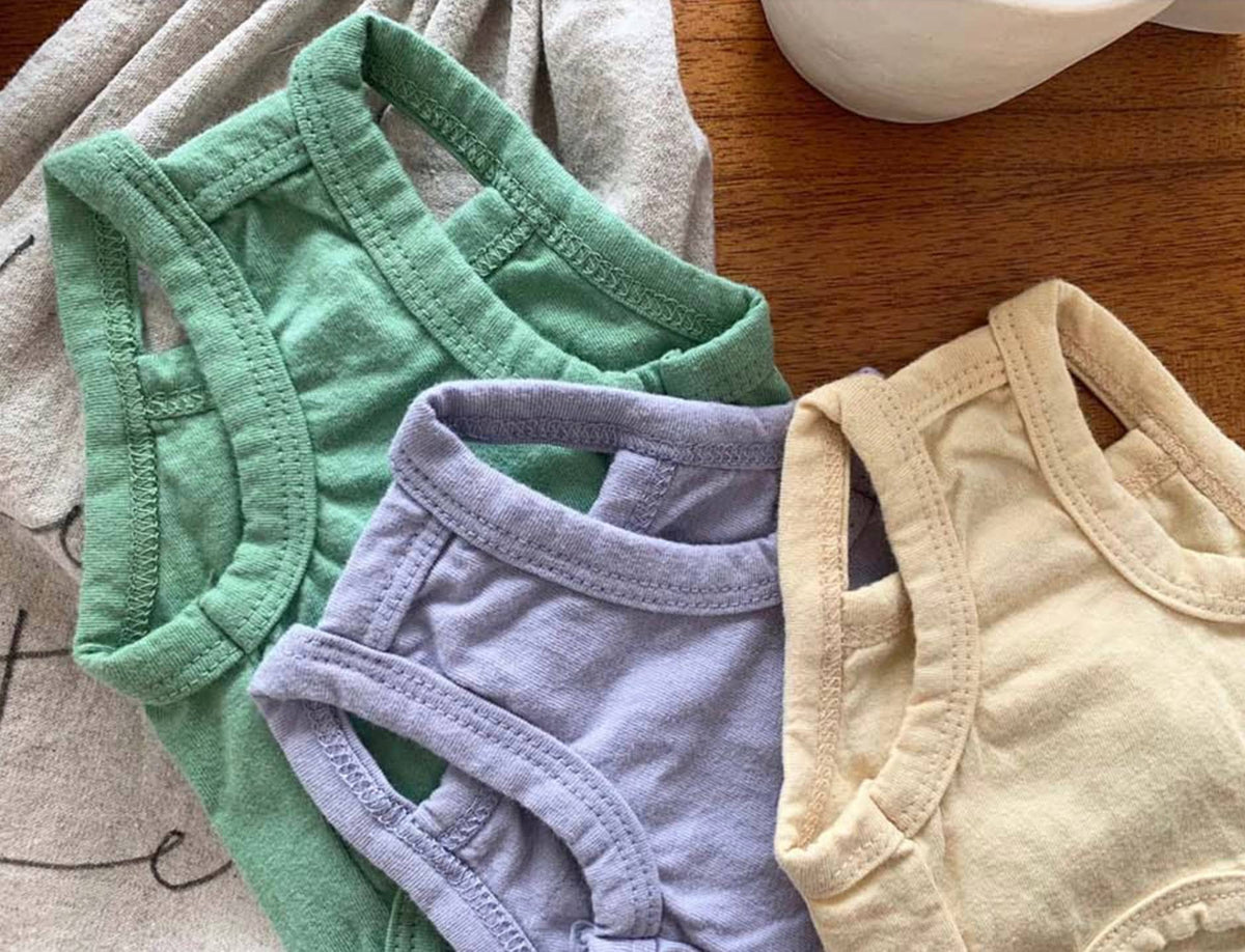 NKpup washed cotton sleeveless dog shirts in green, purple, and cream colors.