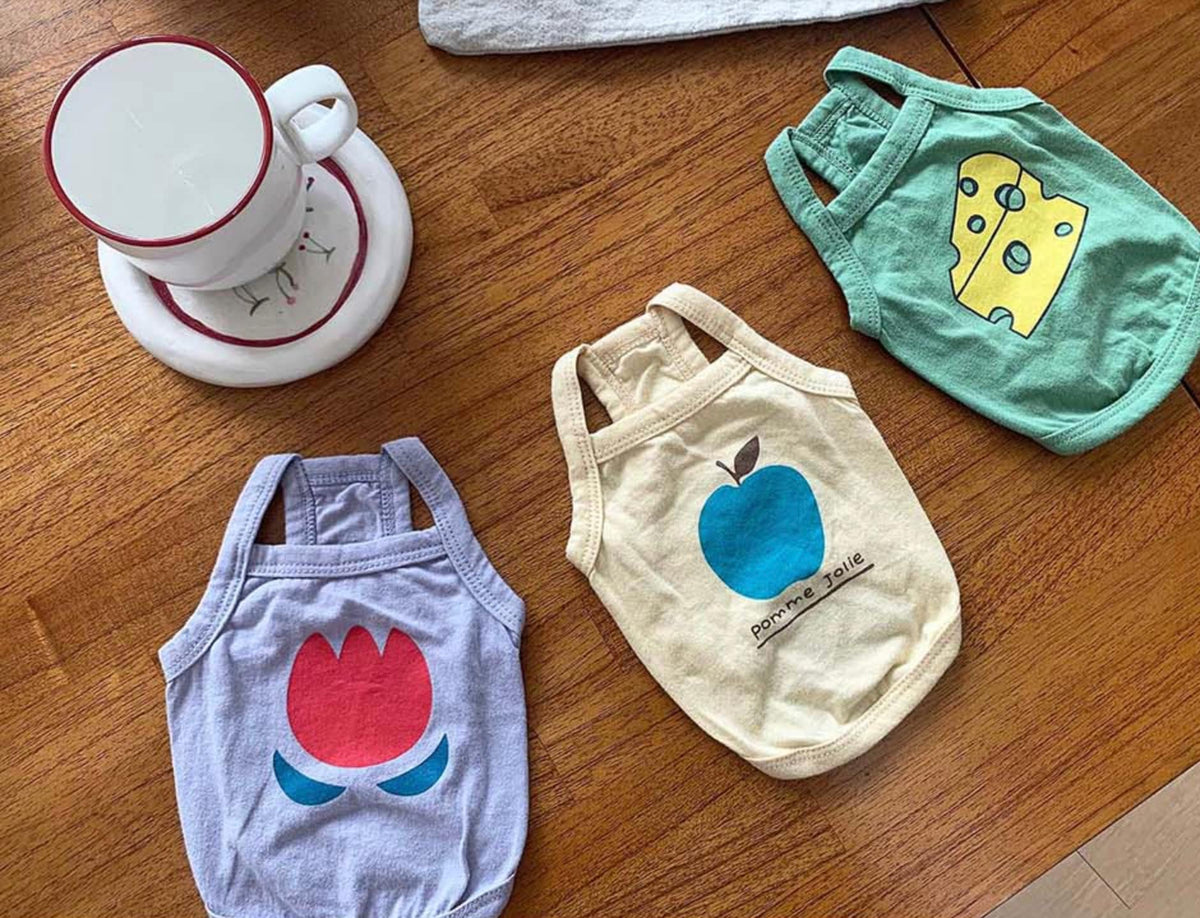 NKpup washed cotton sleeveless dog shirts in purple with tulip, cream with apple, and green with cheese designs