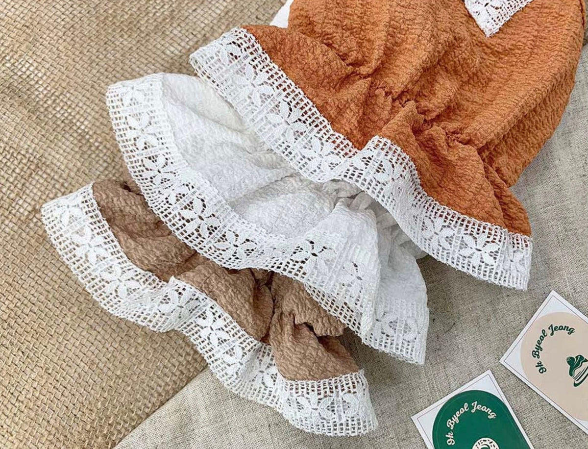 NKpup lace dog dress in orange and beige with white lace trim