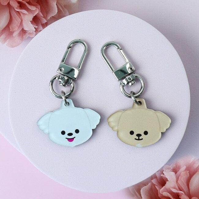 Personalized dog breed pendant charms in light blue and tan with silver lobster clasps.