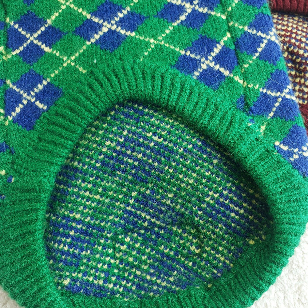 Close-up of a green and blue argyle knit dog vest by NKpup