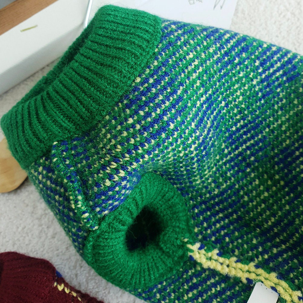 Close-up of the green, blue, and yellow argyle knit pattern on an NKpup vintage dog vest.