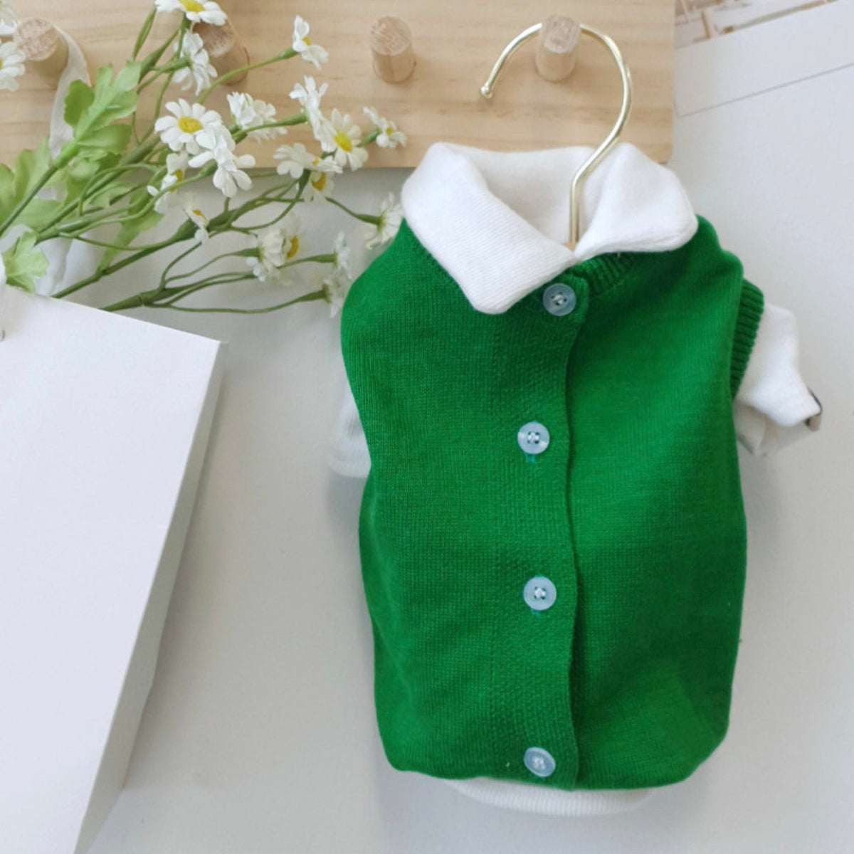 Vivid knit green dog cardigan vest with a white collar and button front.