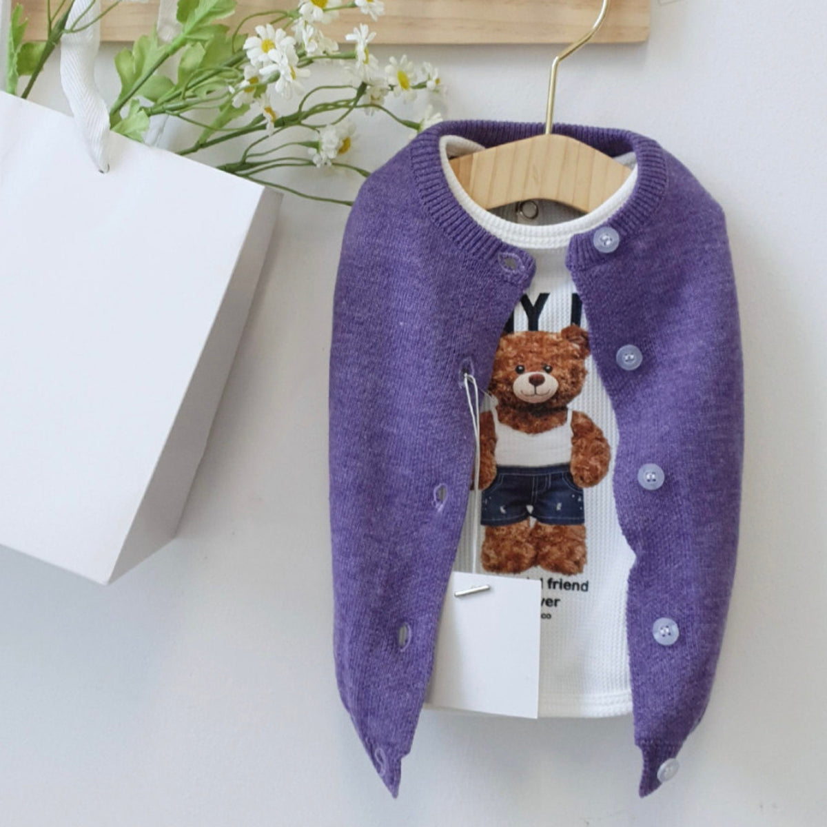 Vivid Knit Dog Cardigan Vest in purple with a white graphic teddy bear shirt.