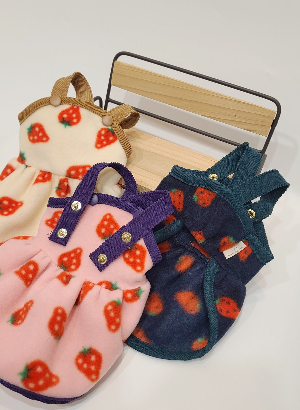 NKpup Strawberry Fleece Dresses for pets in cream, pink, and navy blue with strawberry patterns.