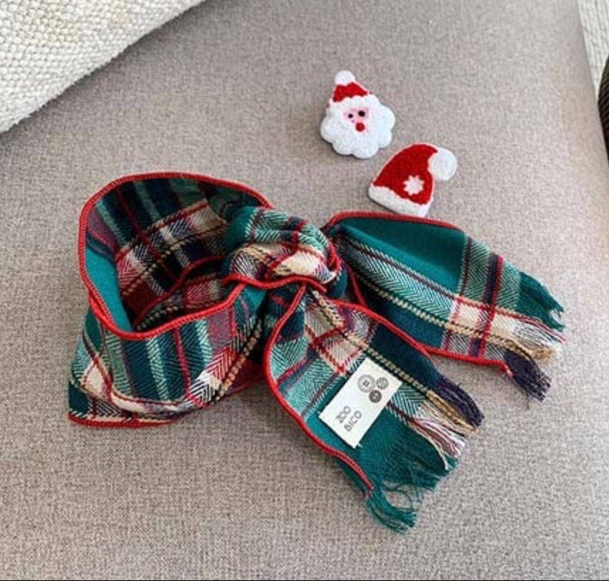 Christmas plaid dog scarf in green, red, and white tartan pattern with fringe edges.