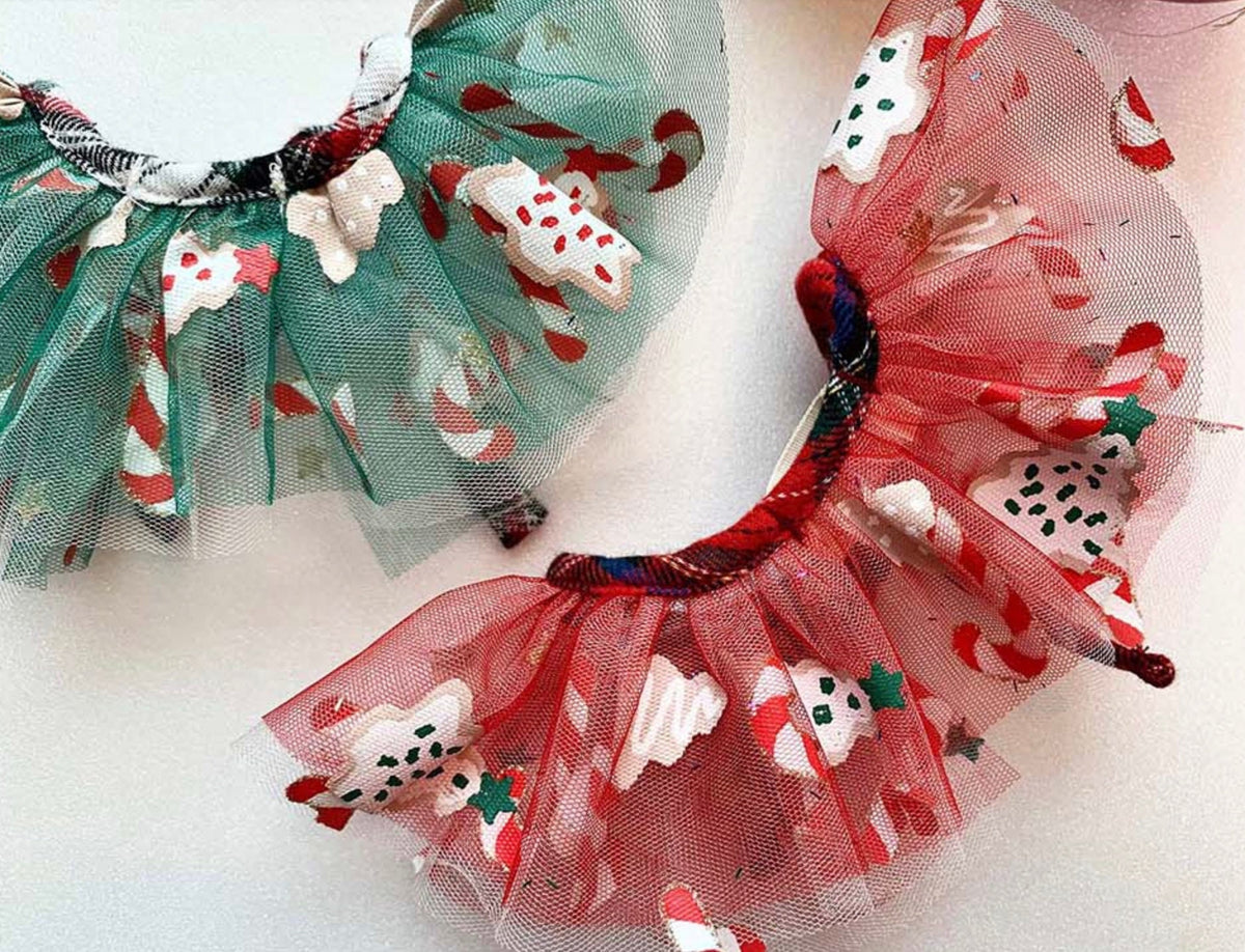 Christmas chiffon dog capes in red and green with festive snowman and candy cane patterns.