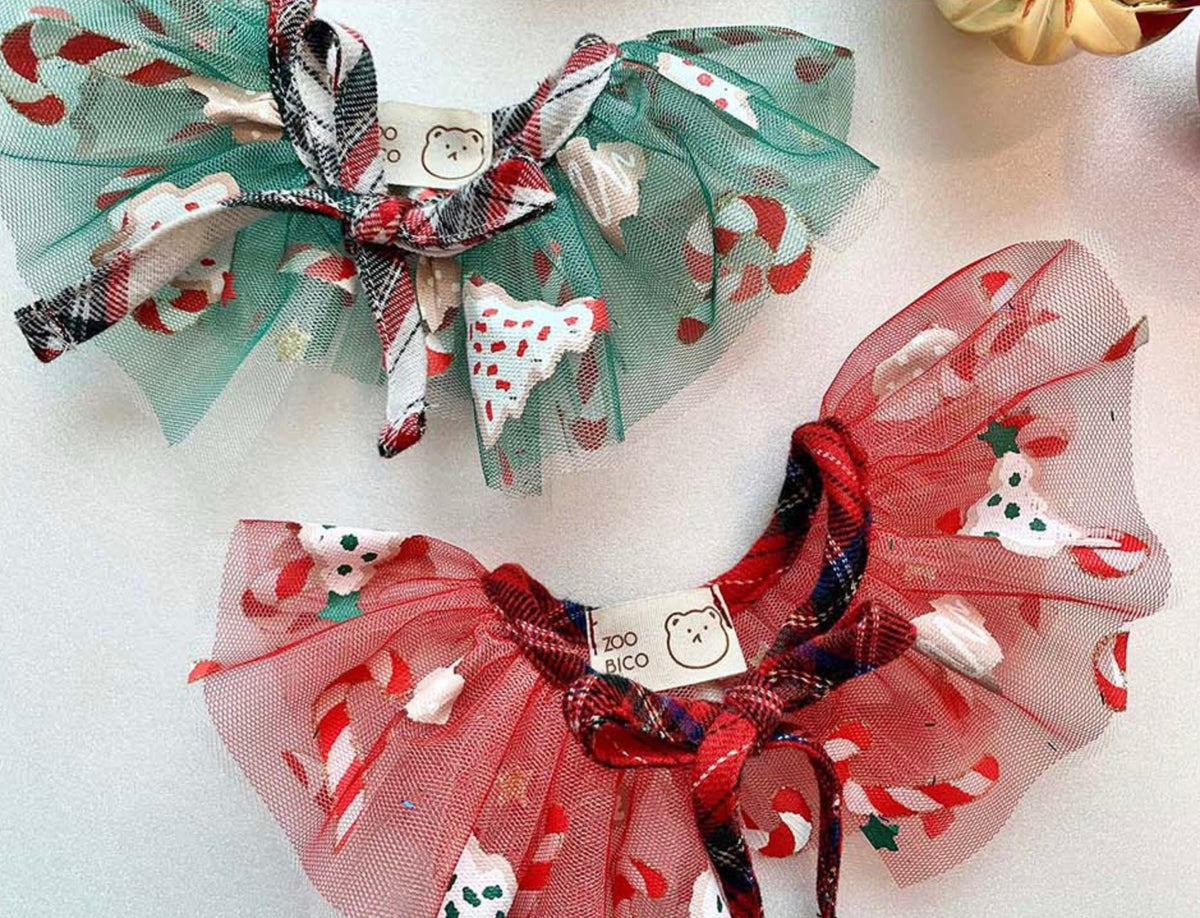 Two NKpup Christmas chiffon dog capes in green and red with festive candy cane patterns.