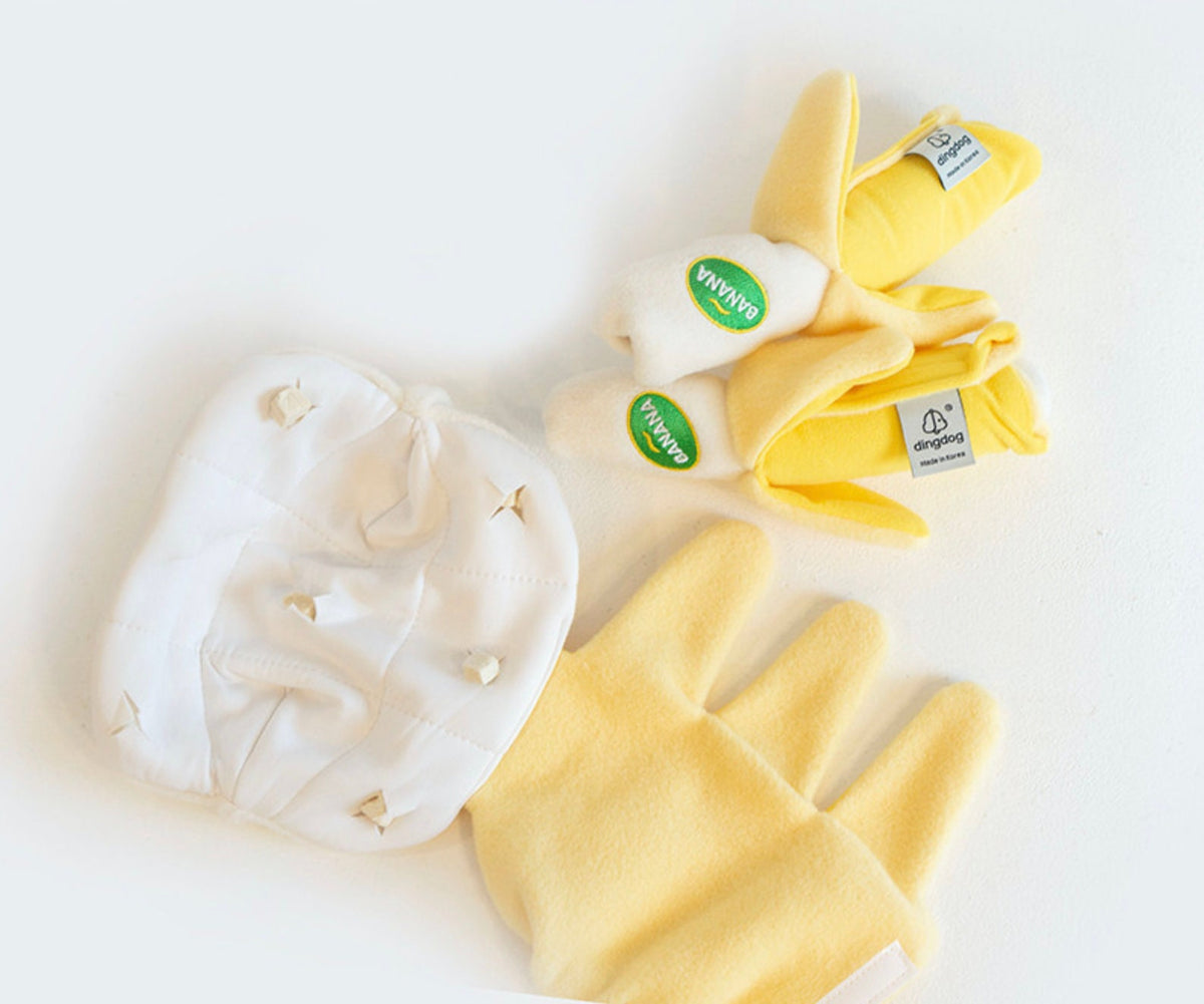 Yellow banana-shaped snuffle dog toy with white fabric components