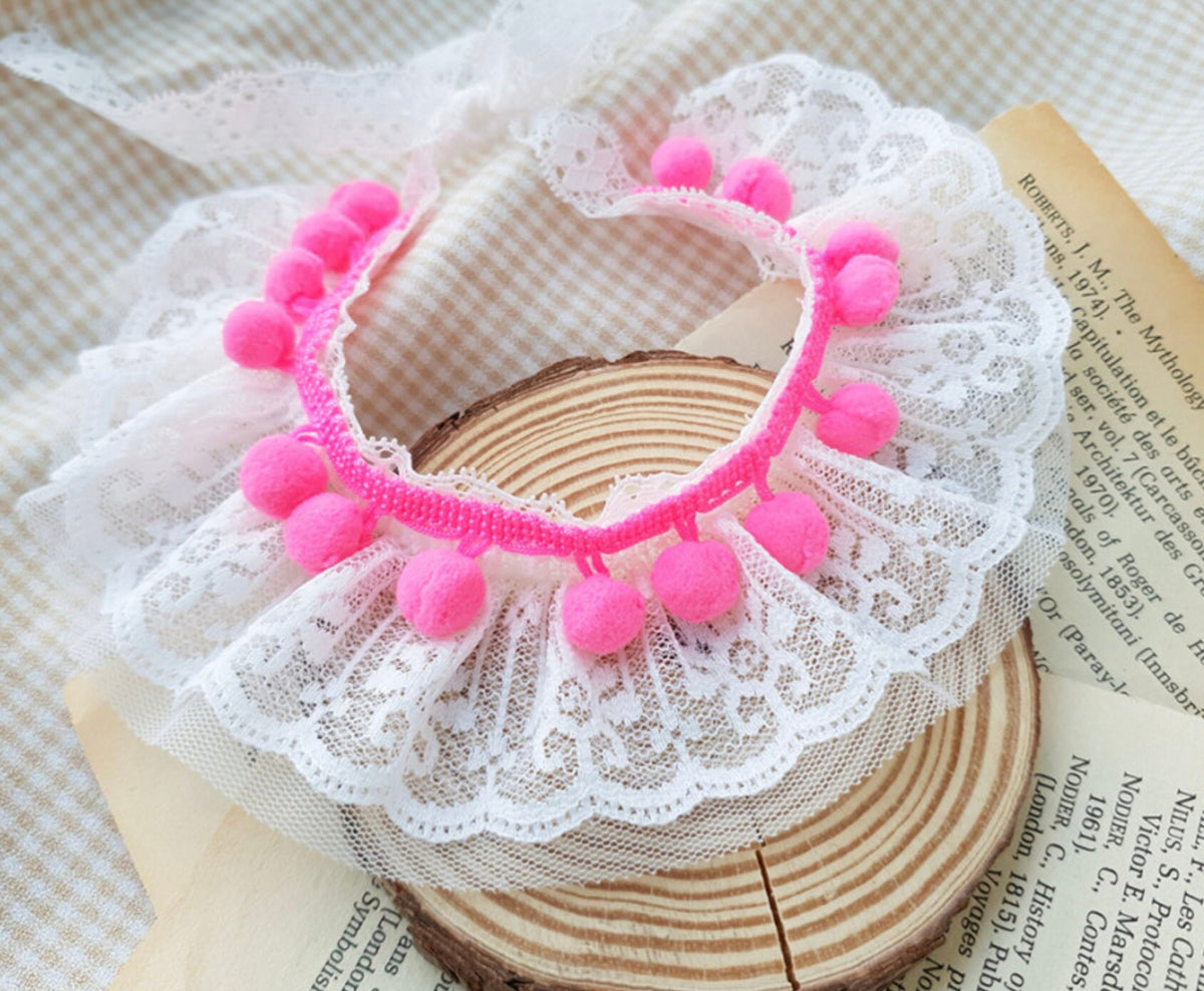 NKpup Lace PomPom dog cape in white lace with pink pompom trim.