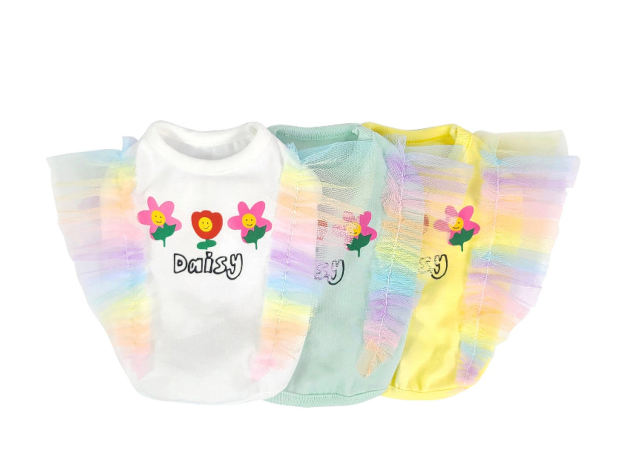Set of three rainbow frilled crop top dog shirts in white, mint, and yellow with flower patterns.