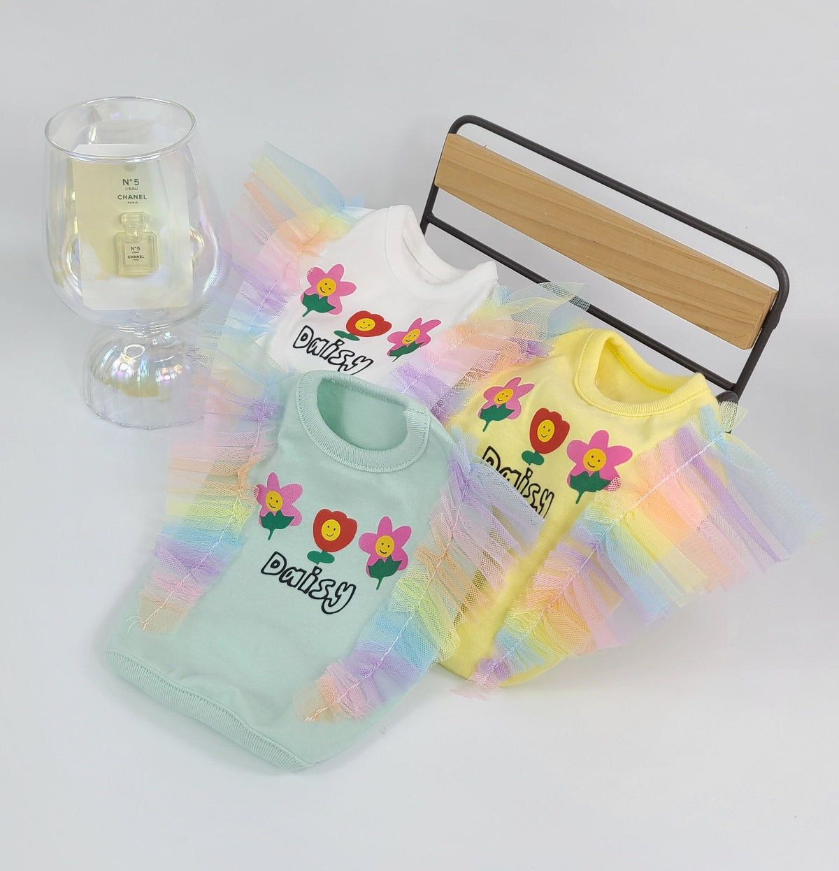 Rainbow Frilled Crop Top dog shirts in mint green and yellow with daisy flower patterns.