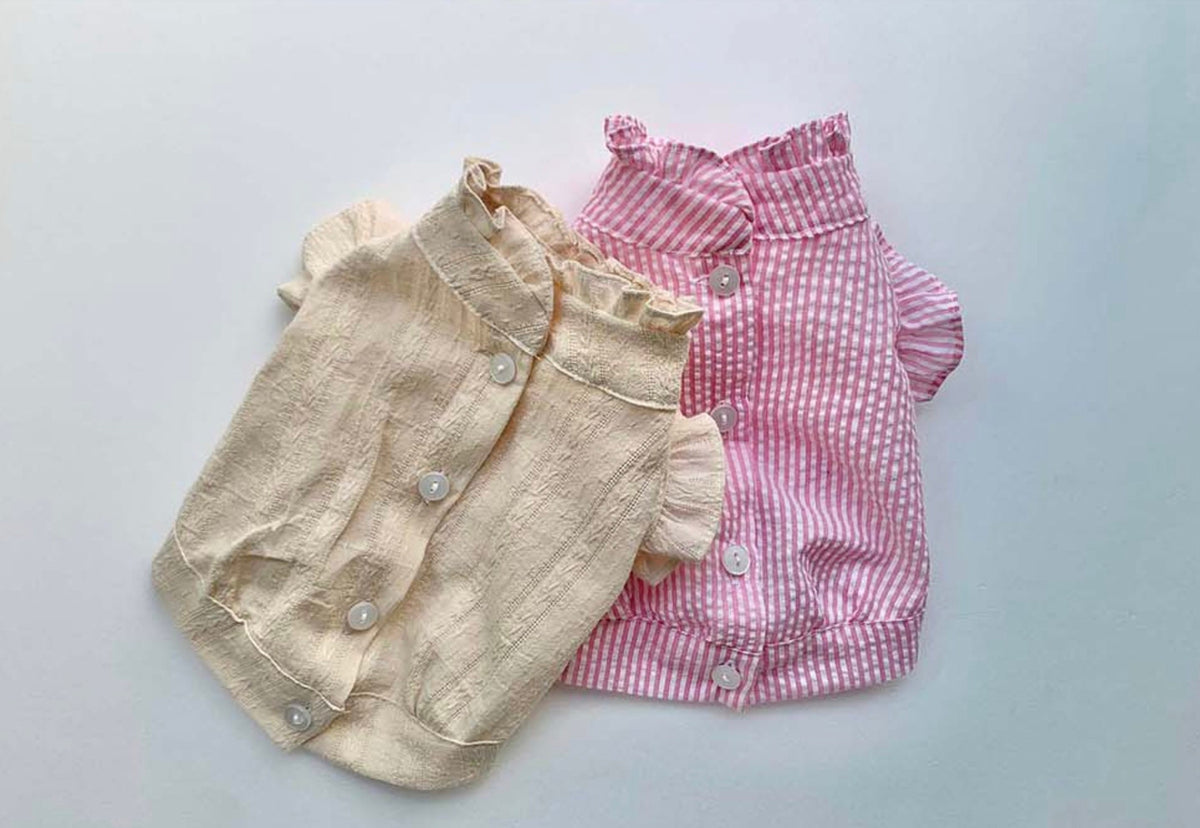 NKpup frilled blouses for dogs in cream and pink gingham patterns with button closures.