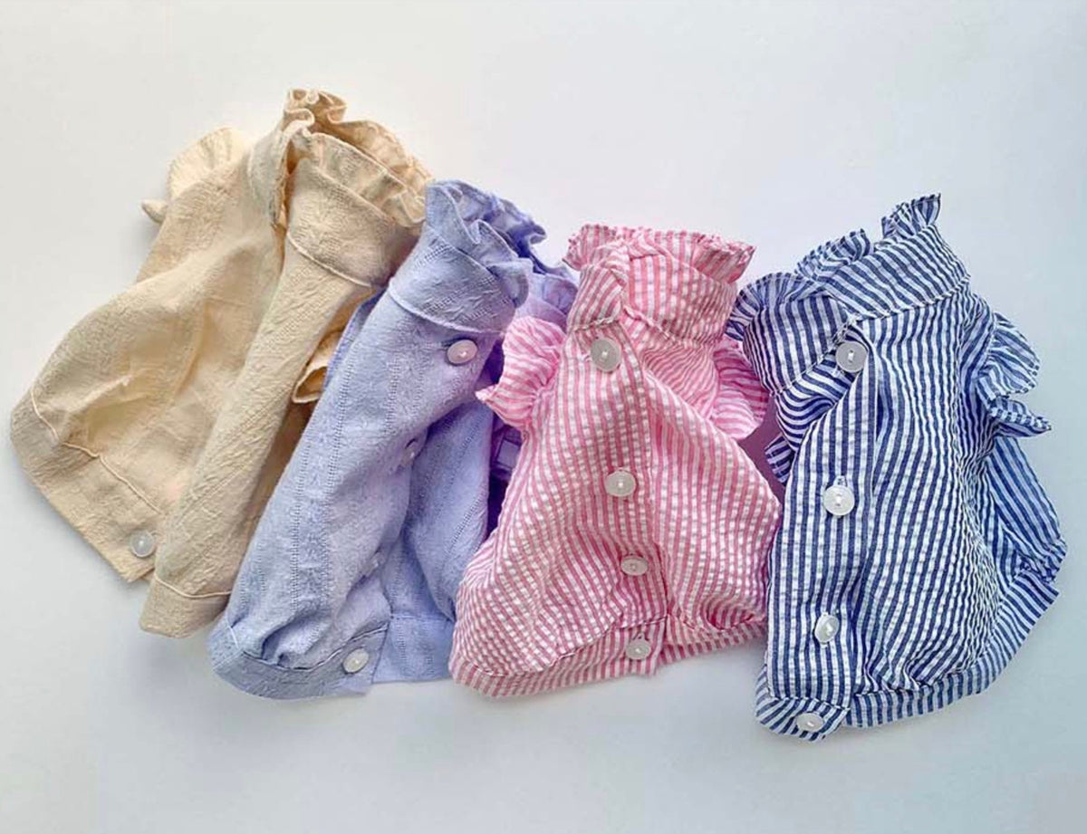 NKpup frilled blouses for dogs in beige, lilac, pink gingham, and blue gingham patterns.