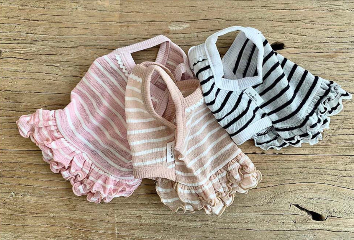 NKpup stripe crop sleeveless dog tops in pink, beige, and white with ruffled hems.