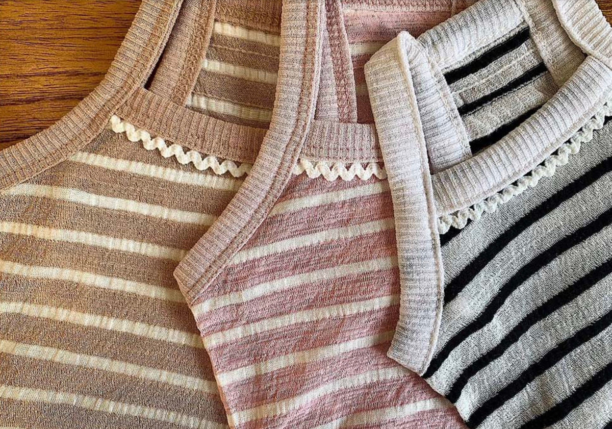 Three striped sleeveless crop tops for pets in beige, pink, and black and white patterns.