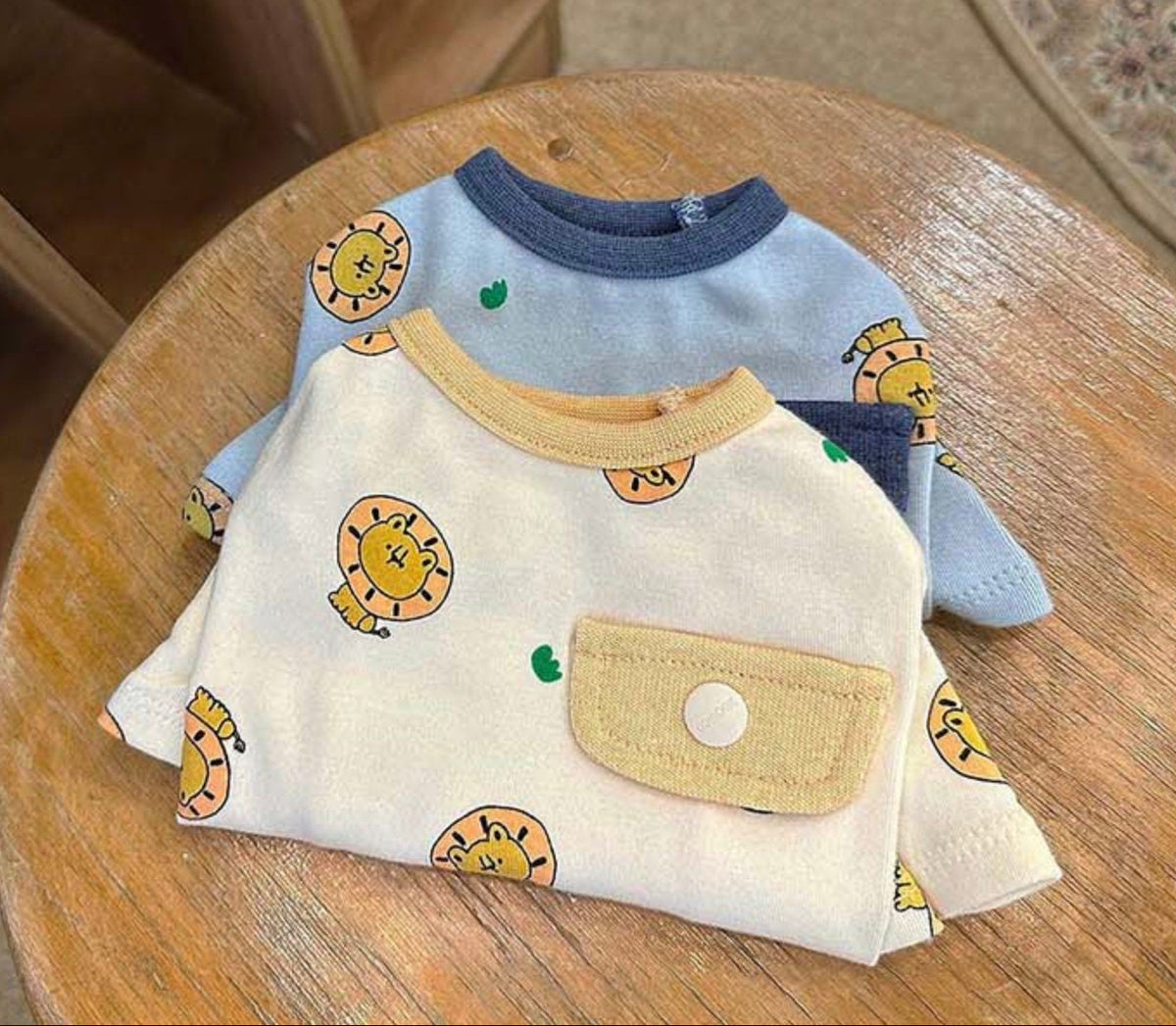 NKpup Lion Print Dog Shirts in light blue and cream with cute lion patterns and a front pocket.