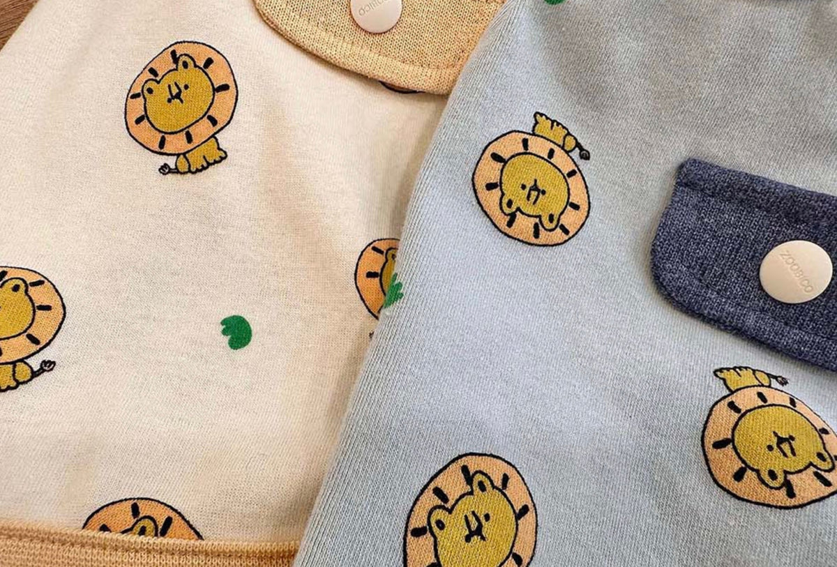 Cream and light blue NKpup dog shirts featuring a cute lion print pattern.