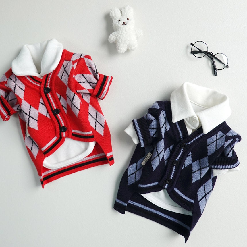 Red and navy NKpup argyle knit dog cardigans with white collars.