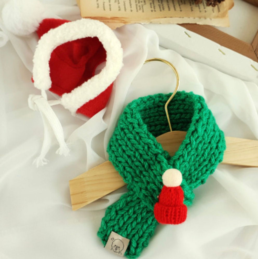 Handmade green knit Christmas dog scarf with a small red Santa hat ornament by NKpup