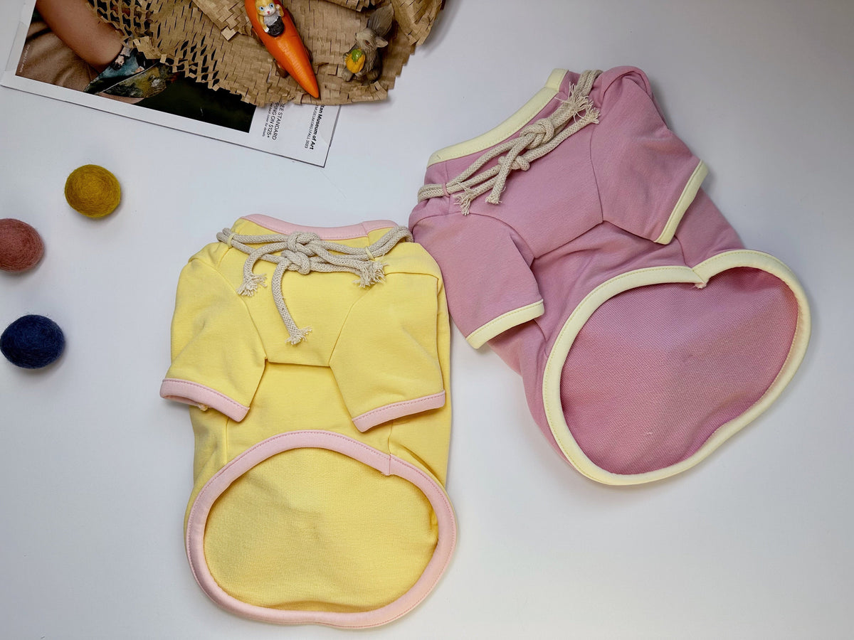 Yellow and pink Bunny Bag dog shirts with drawstring details.