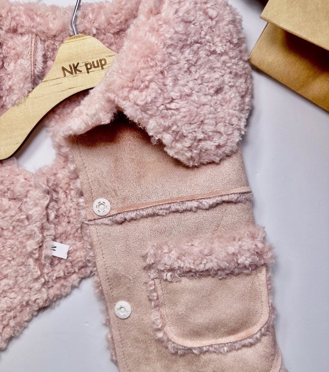 Pink luxury velvet dog vest with soft sherpa fleece trim and button closure.