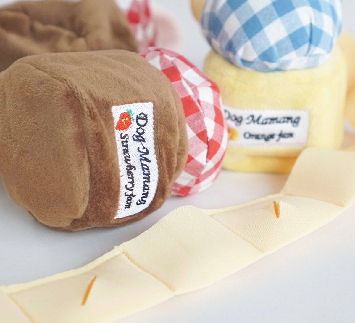 NKpup Snuffle Jam dog toy featuring plush strawberry and orange jam character designs.