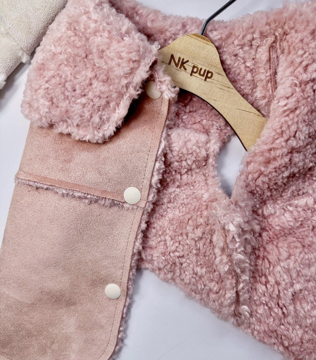 Luxury pink velvet dog vest with soft sherpa fleece lining and snap button closures.