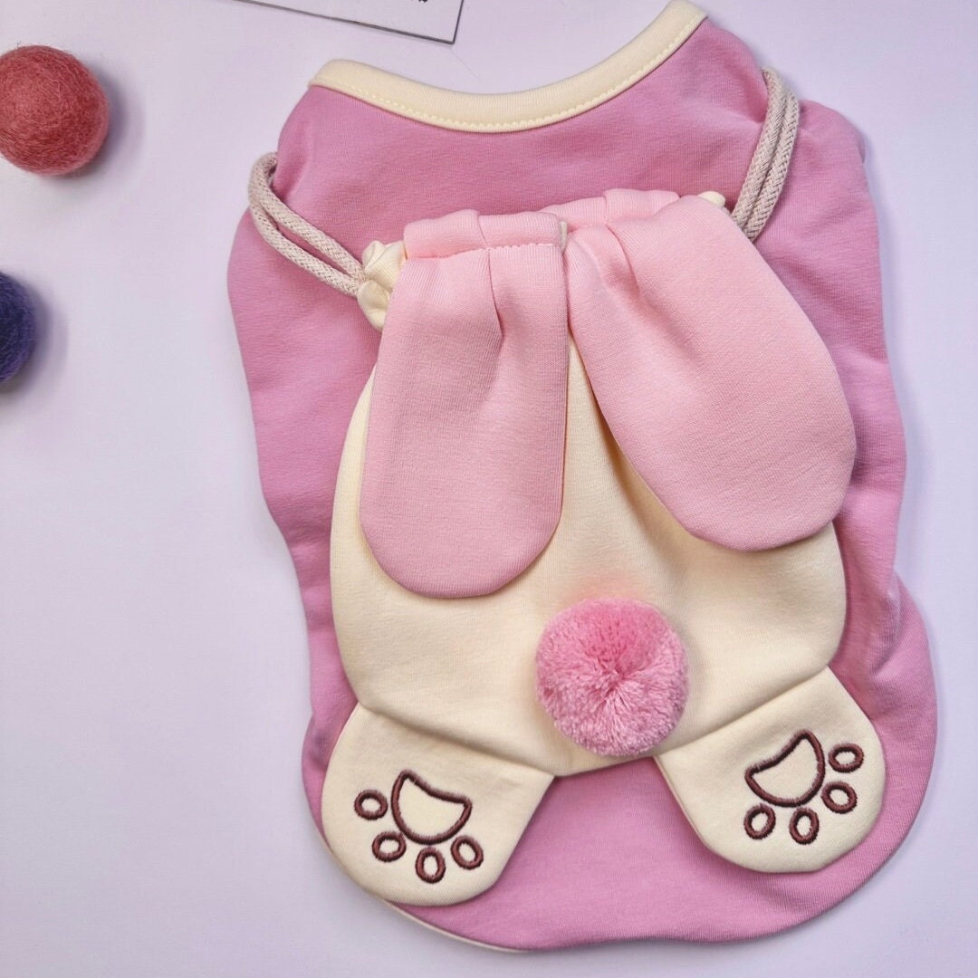 NKpup Bunny Bag Dog Shirt in pink with large bunny ears and a fluffy pom-pom detail